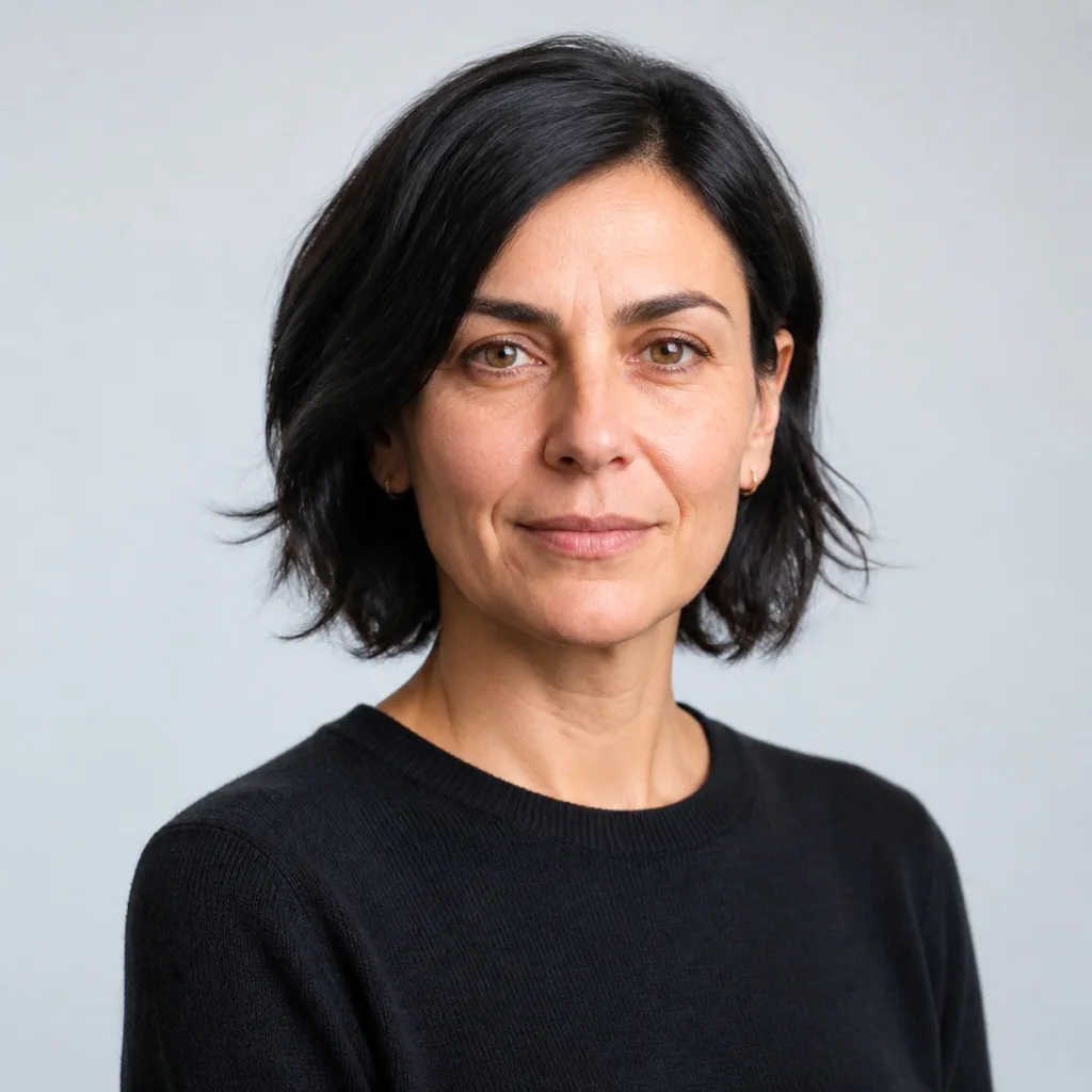 Studio portrait of Camille Laurent, policy director.